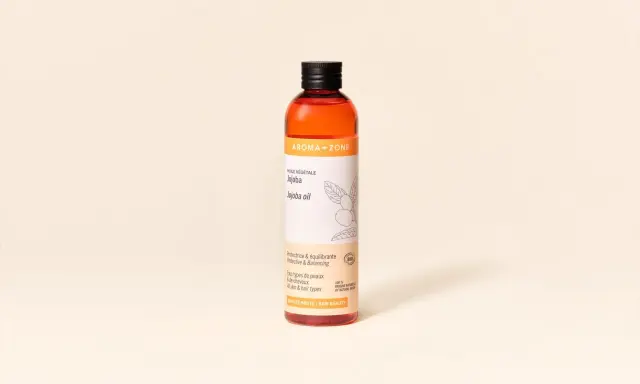 Flacon d'huile de jojoba Aroma-Zone, aux multiples bienfaits pour la peau et les cheveux.