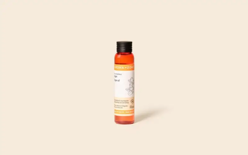 Flacon d'huile d'argan Aroma-Zone. Bien que ses effets secondaires soient rares, cette huile est réputée pour ses bienfaits régénérants et nourrissants.